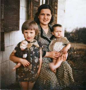 Tanya Dumesh with her daughters Raisa (on the left with a doll) and Julia (on Tanya's knee).  First days back in Vishki after her long wanderings.<br>